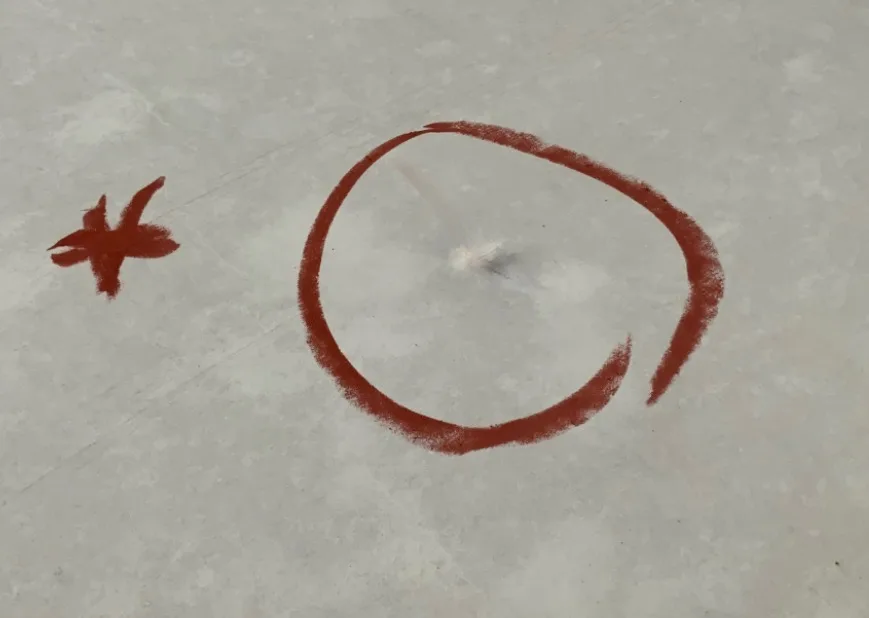 Hail hit marked on a commercial roof membrane during inspection