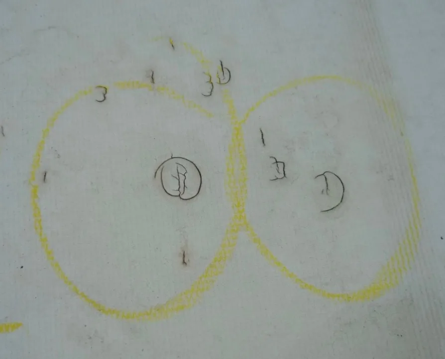 Hail hits chalk-marked on a commercial membrane roof