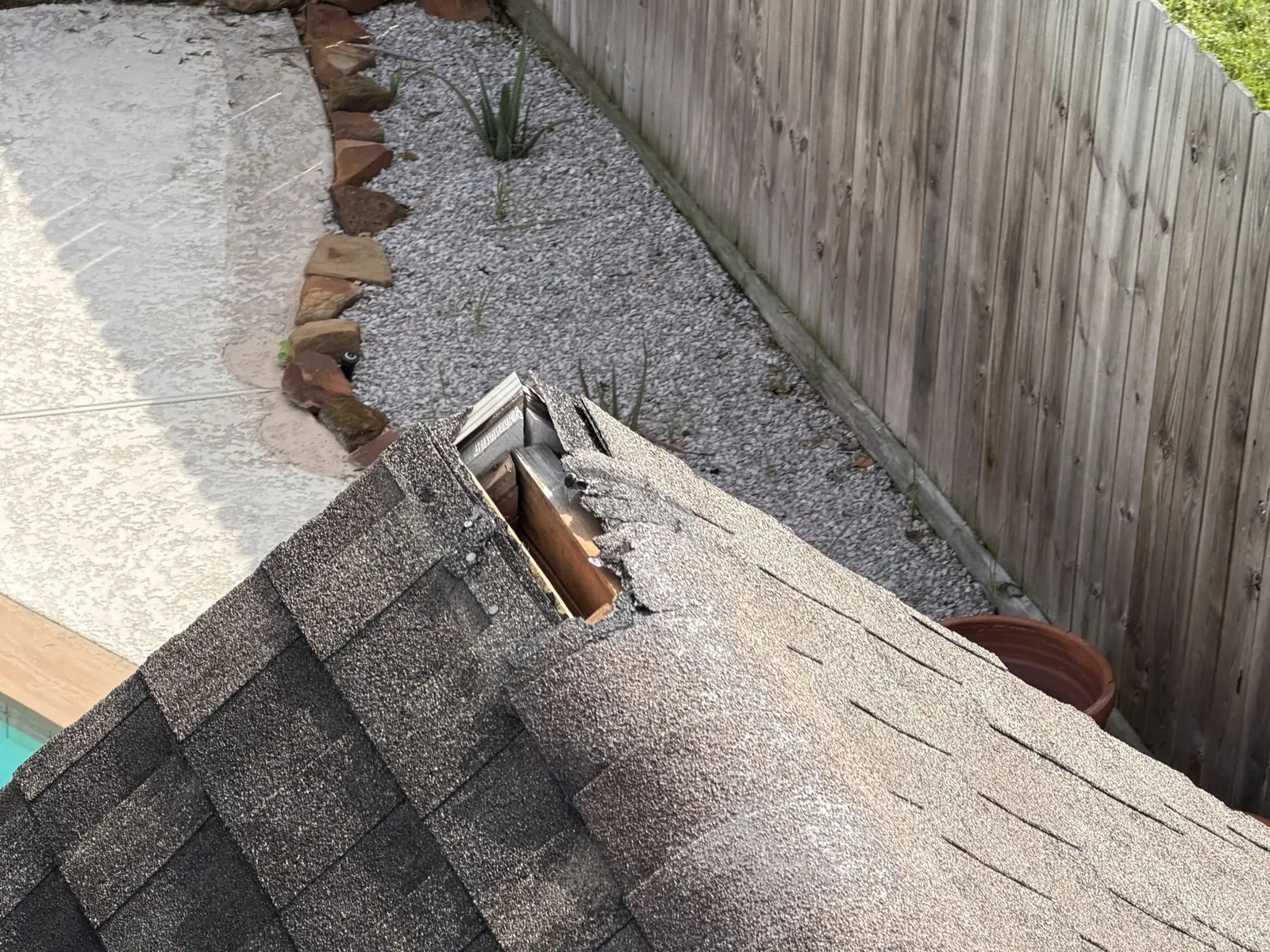 Creased ridge shingle from storm wind