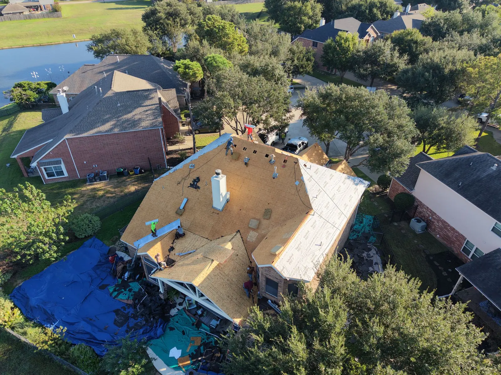 Roof replacement in progress on a lake home