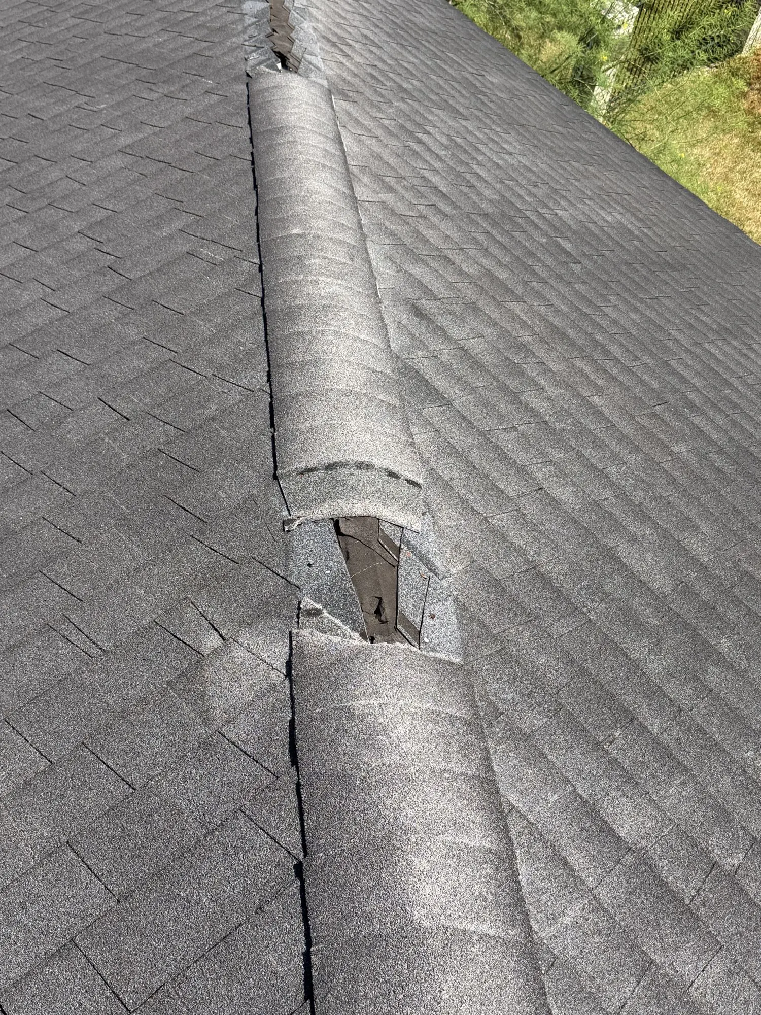 Wind-damaged ridge cap