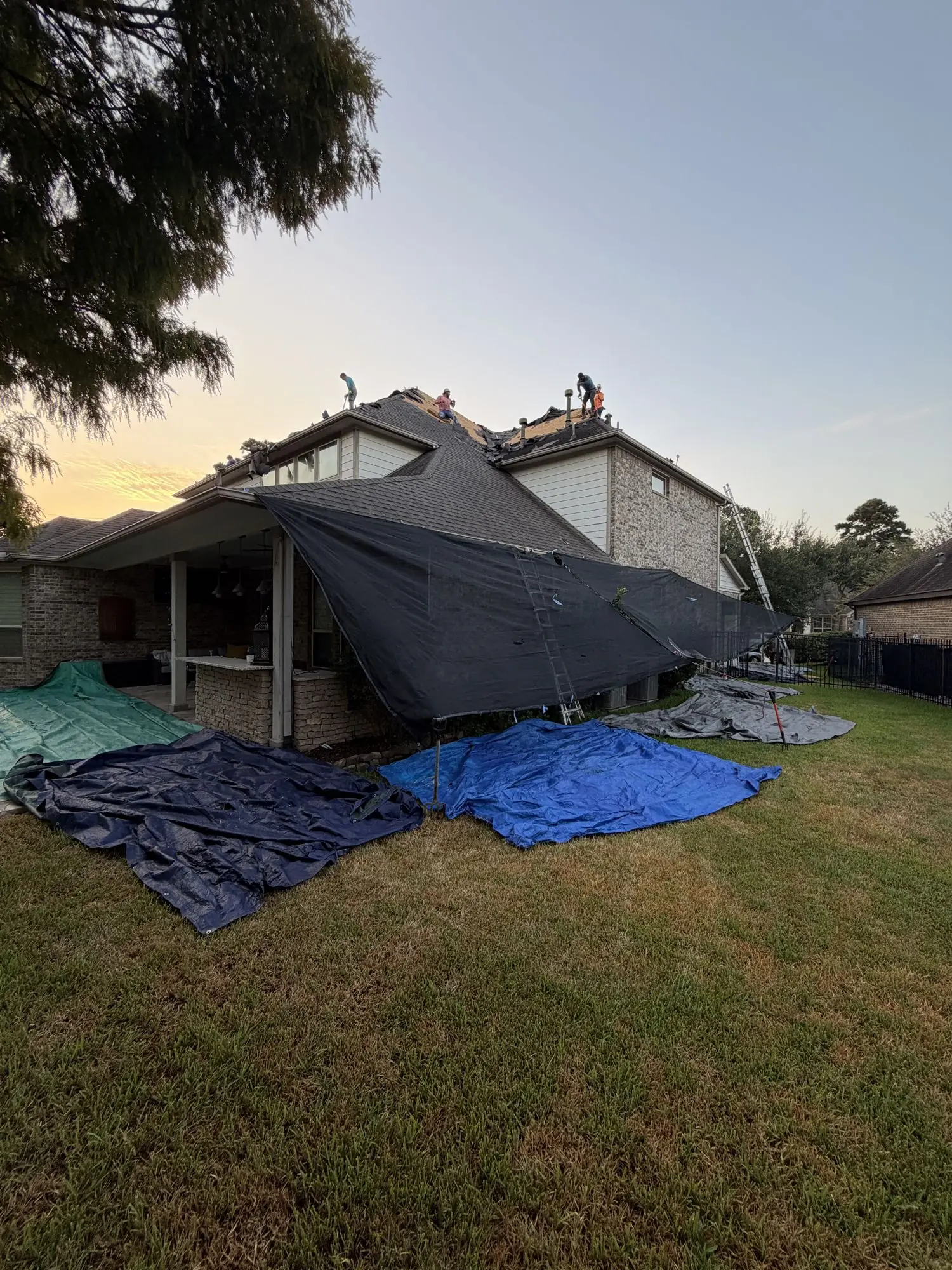 Tarps protecting the yard during a re-roof